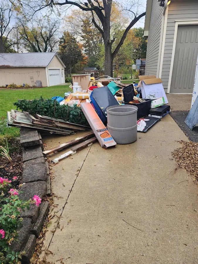 Dumpster being loaded with debris for Estate Cleanout Dumpster Rental in Courtland